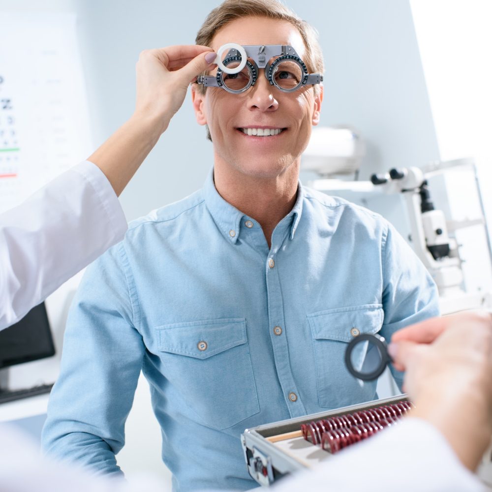 ophthalmologist-examining-middle-aged-man-eyes-with-trial-frame-and-lenses.jpg