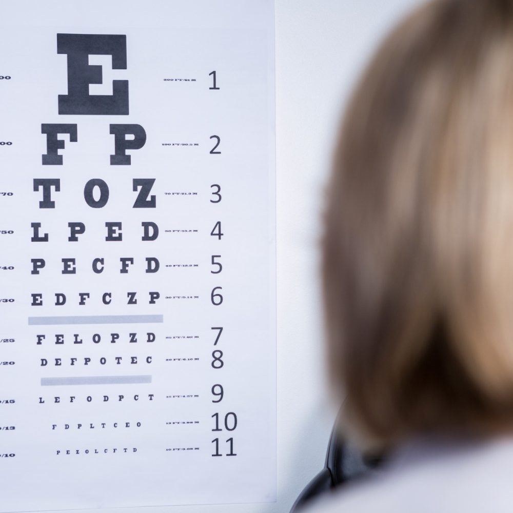 optometrist-looking-at-eye-chart.jpg